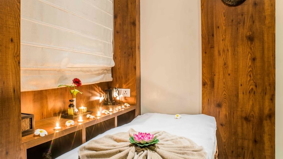 A neatly made bed with decorative elements in a room at The Citi Residenci Hotel, Durgapur.