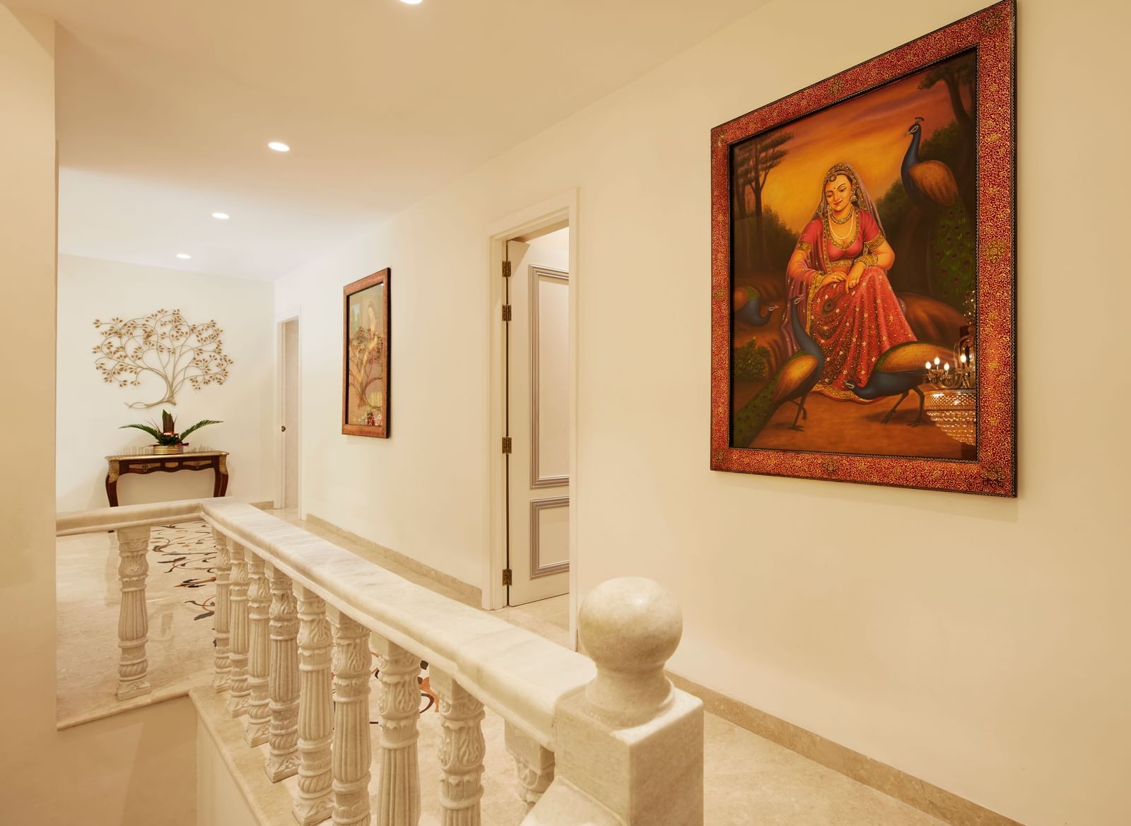 A wide hallway with textured walls, a vibrant painting, and elegant railings - Kaldan Samudhra