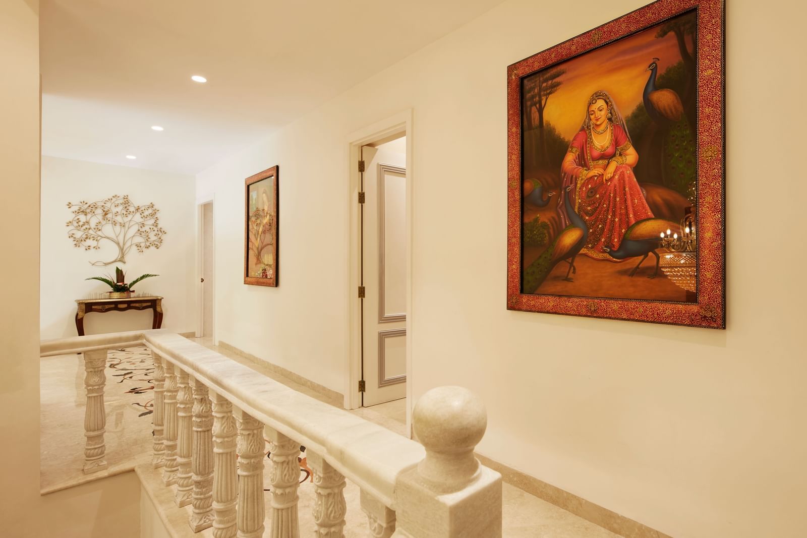 A wide hallway with textured walls, a vibrant painting, and elegant railings - Kaldan Samudhra