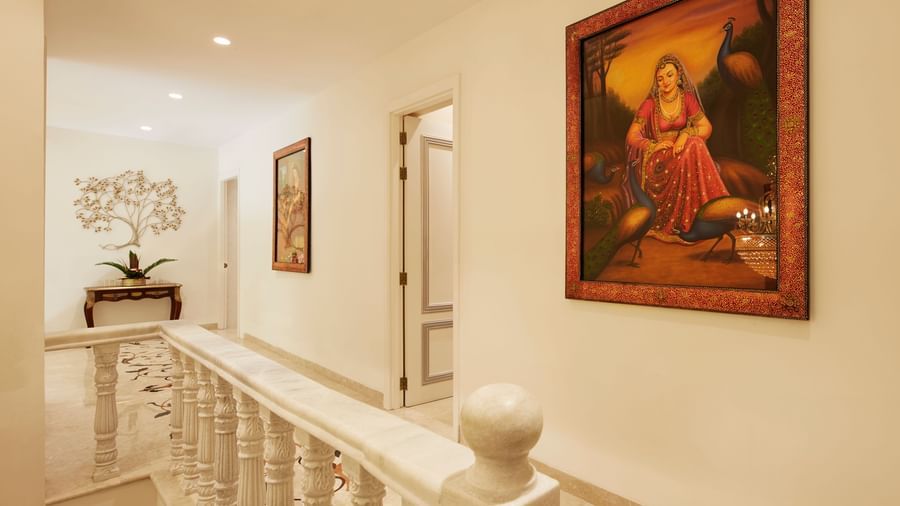A wide hallway with textured walls, a vibrant painting, and elegant railings - Kaldan Samudhra