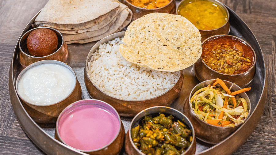 A traditional Indian thali meal served with various dishes at Lotus Leaf Boutique Hotel.