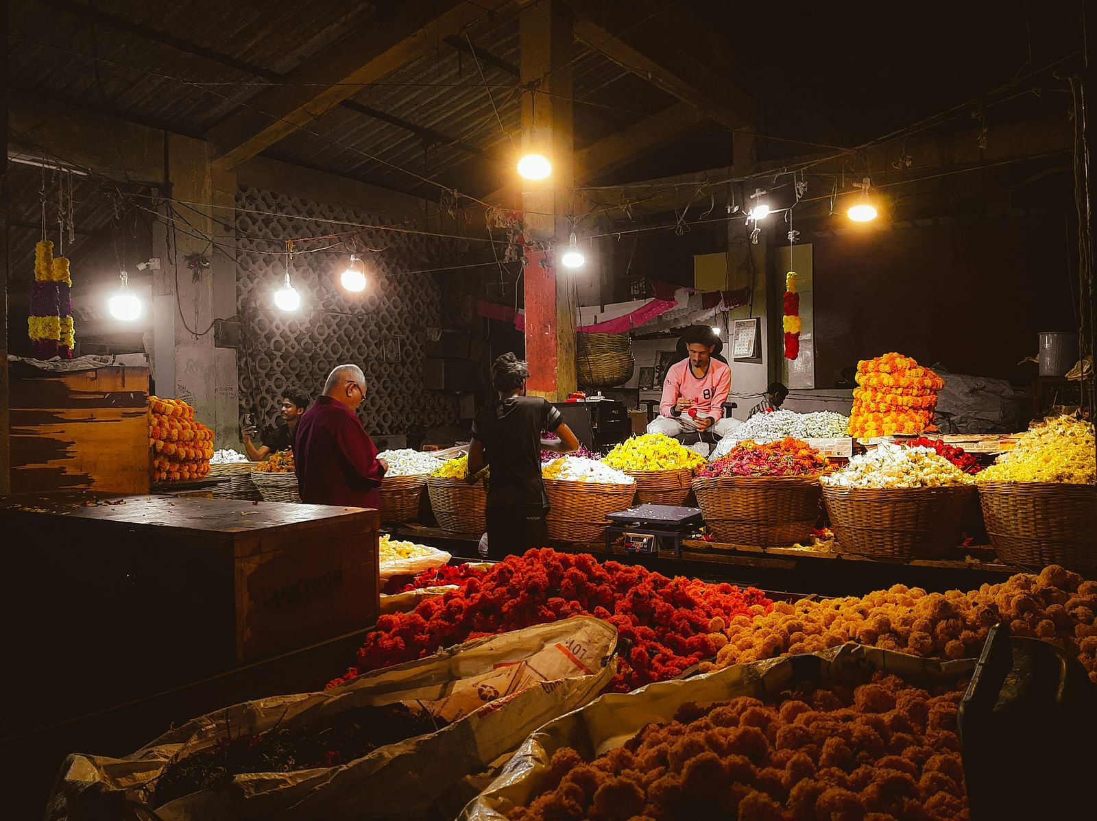Different street vendors selling flowers in Arpora Night Market