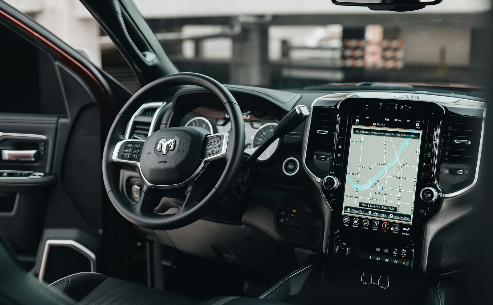 An overview inside a car with the steering, dashboard and centre console in view