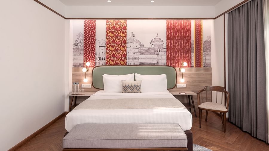 A comfortable hotel bedroom with a bed and a seating area.