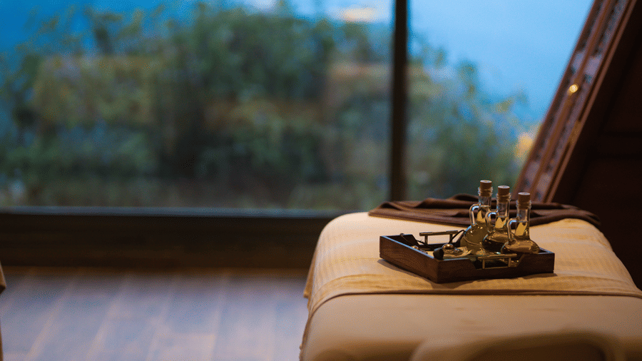 Medicinal oils and herbs placed on a spa bed.