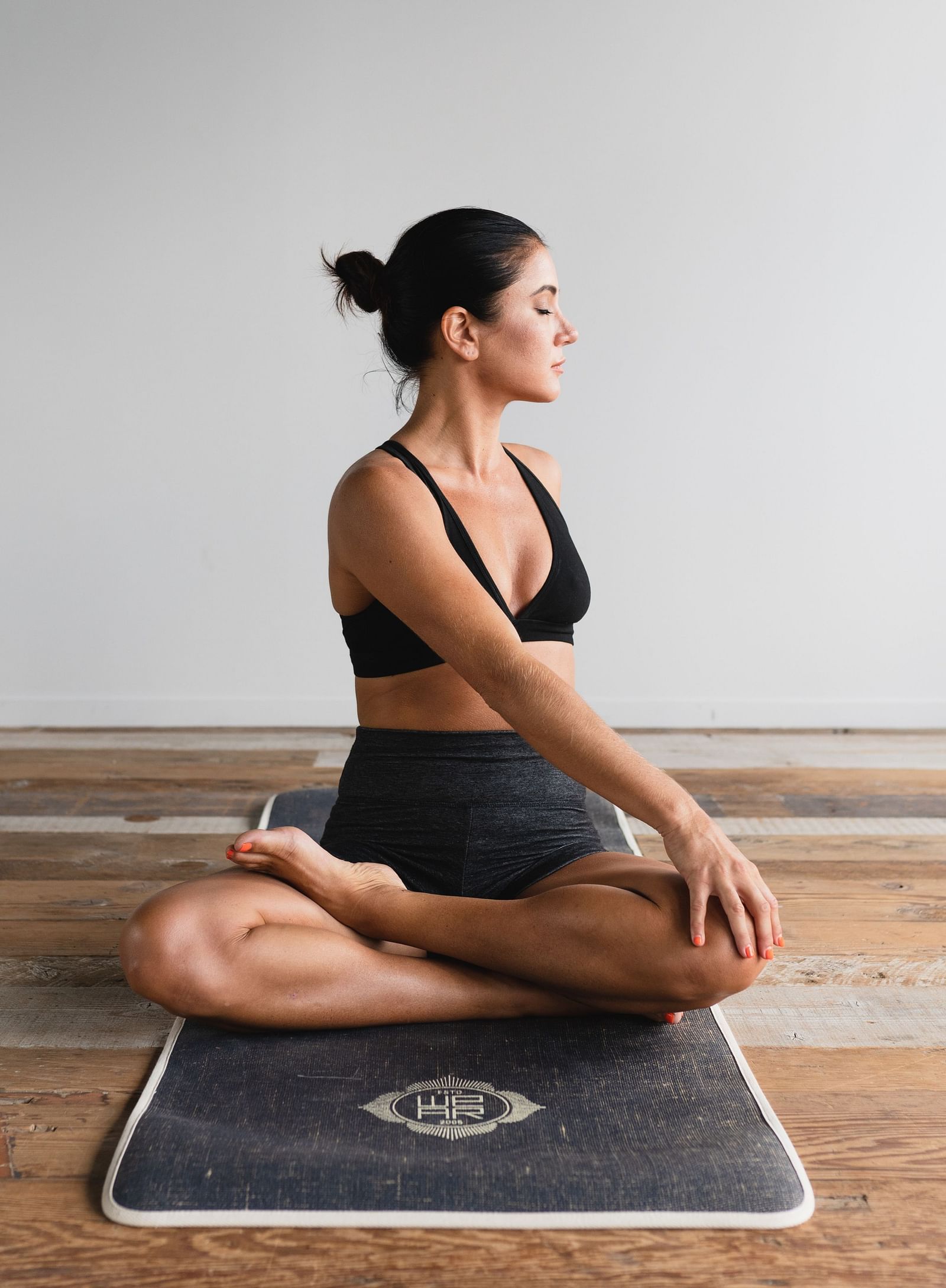 A woman practicing yoga on a mat - Monsoon and ayurveda - gamyam Retreat