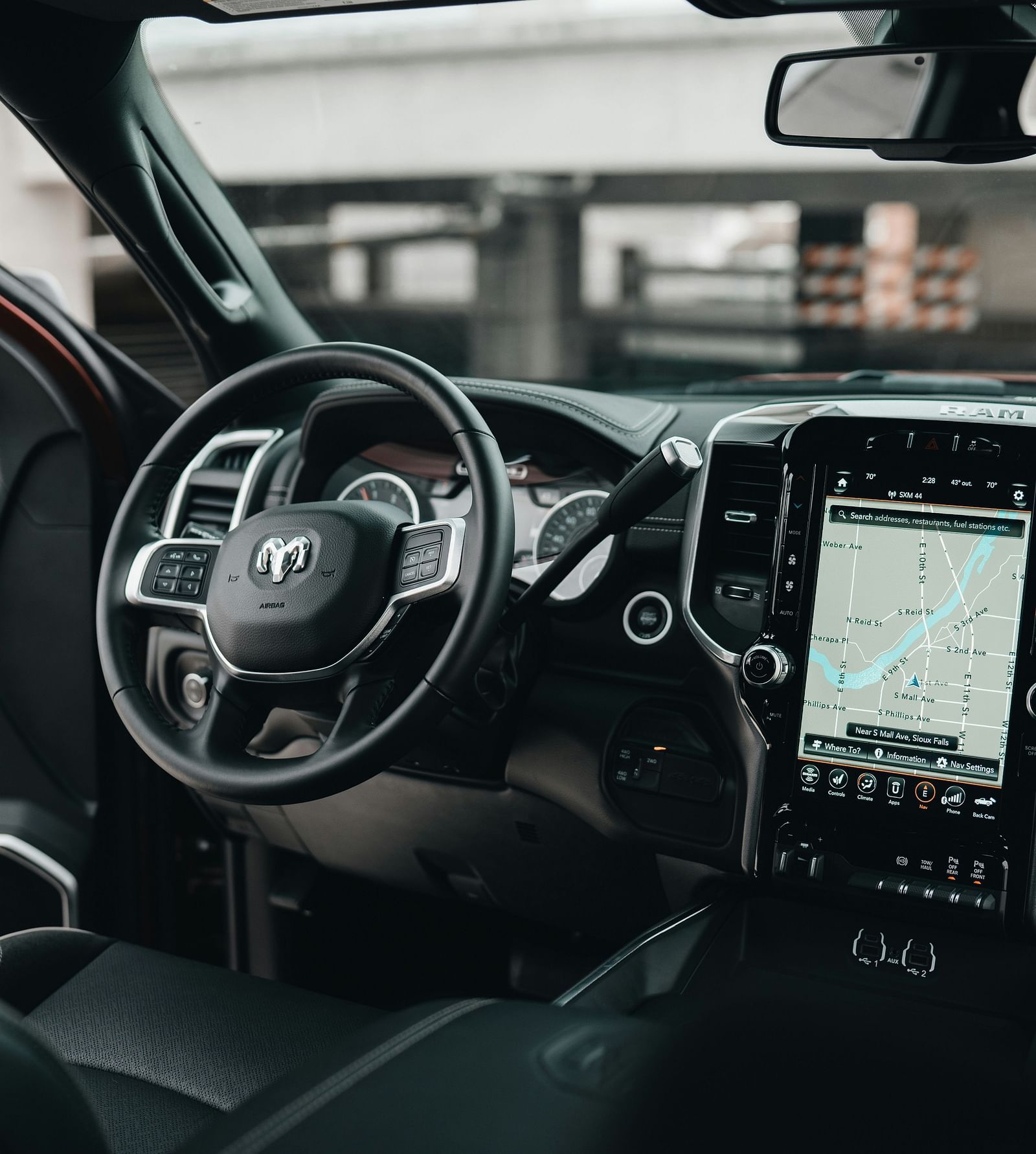 An overview inside a car with the steering, dashboard and centre console in view
