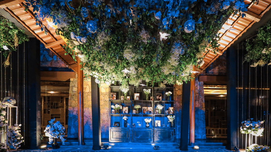 The lavish entrance area at Ananta Spa & Resort, Jaipur, features a dense, illuminated canopy of white flowers and foliage overhead.