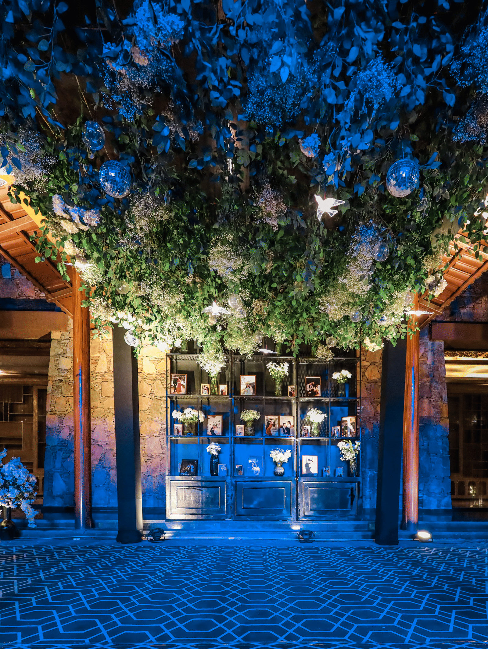 The lavish entrance area at Ananta Spa & Resort, Jaipur, features a dense, illuminated canopy of white flowers and foliage overhead.