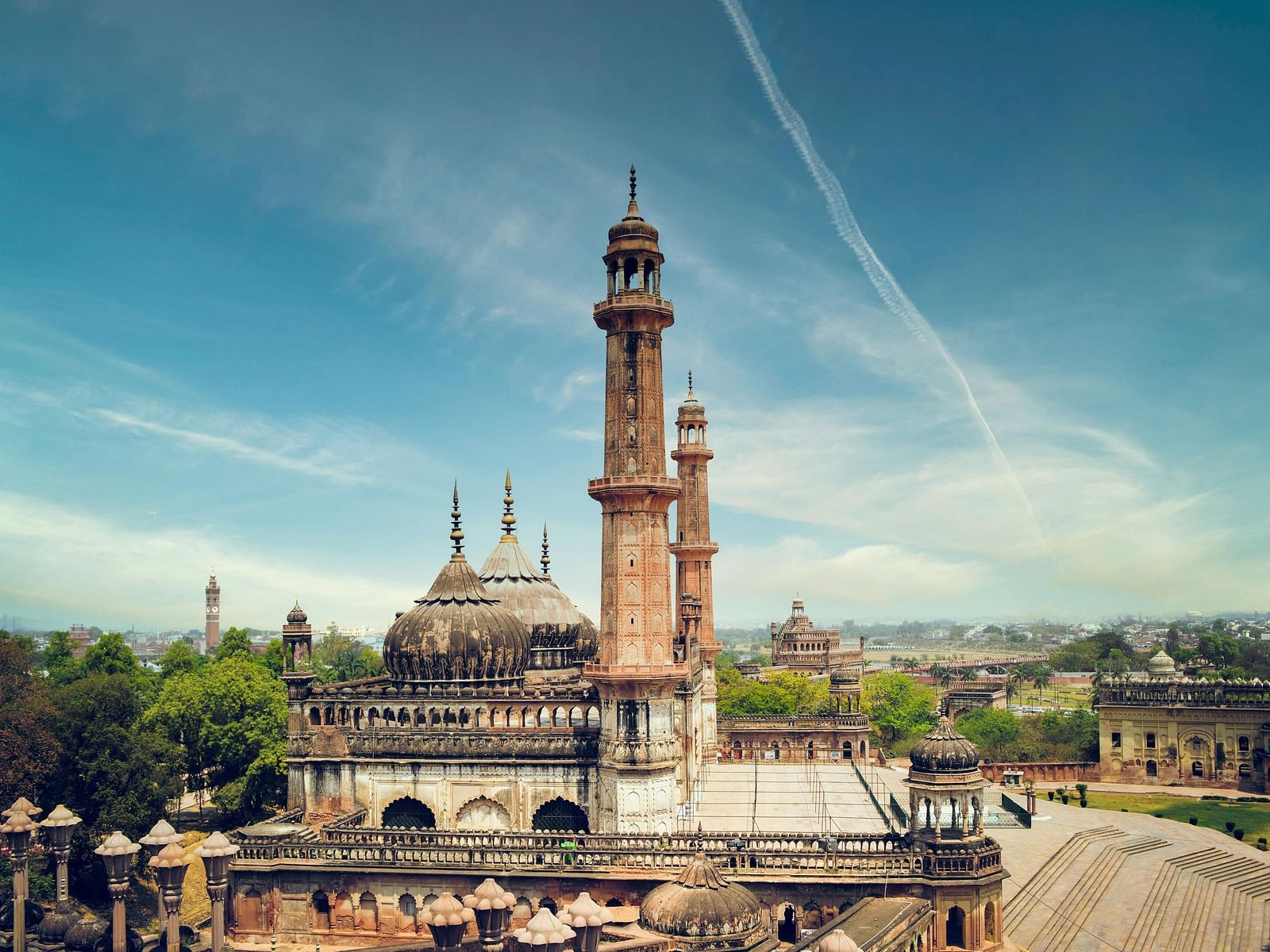 The Bara Imambara in Lucknow, featuring striking Mughal architecture with the imposing Asafi Mosque and a grand central courtyard.