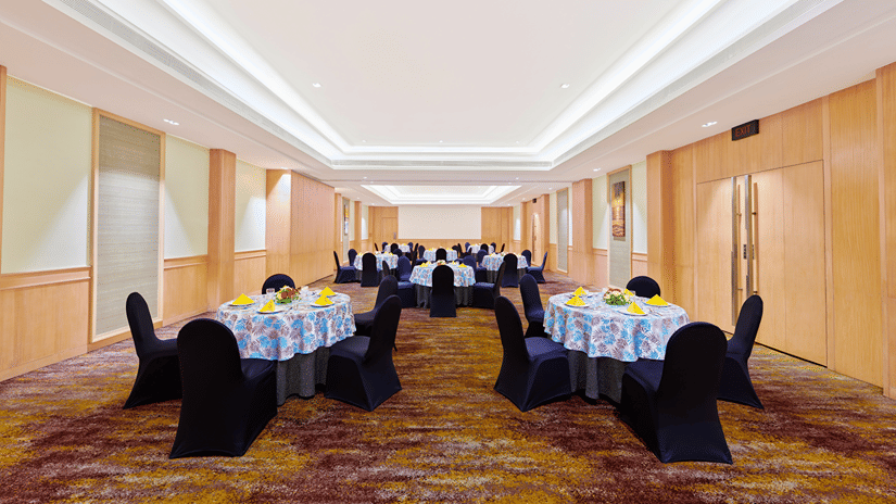 An overview of round table seating arrangement inside Coral event Space at The Resort, Mumbai.
