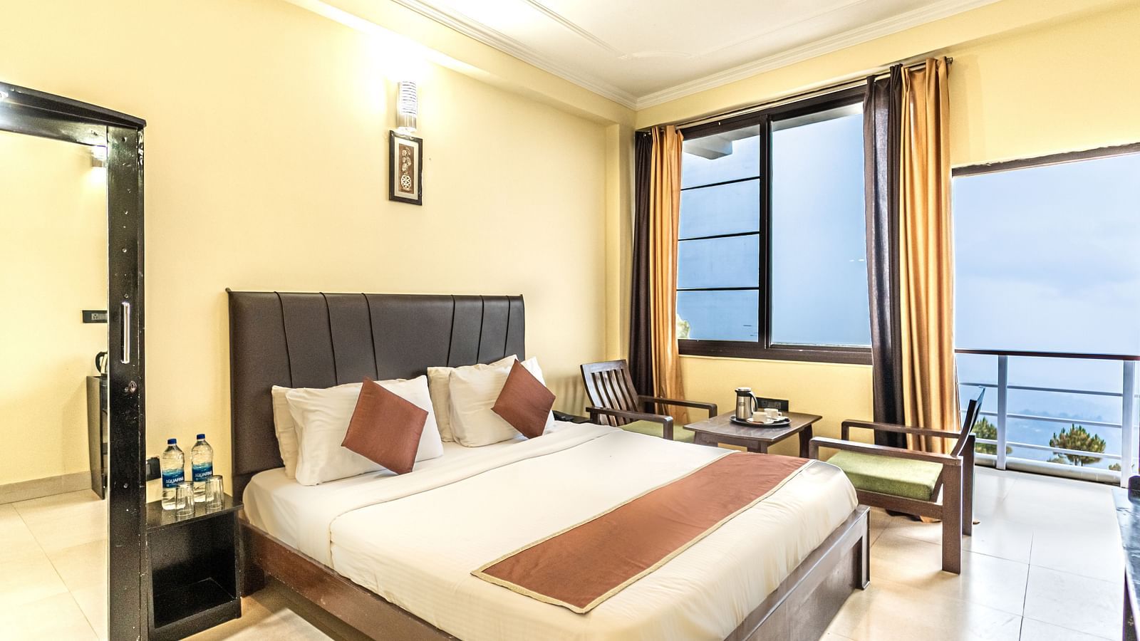 a view of a bedroom at Flutter Hotels & Resorts decked with a bed and a wardrobe