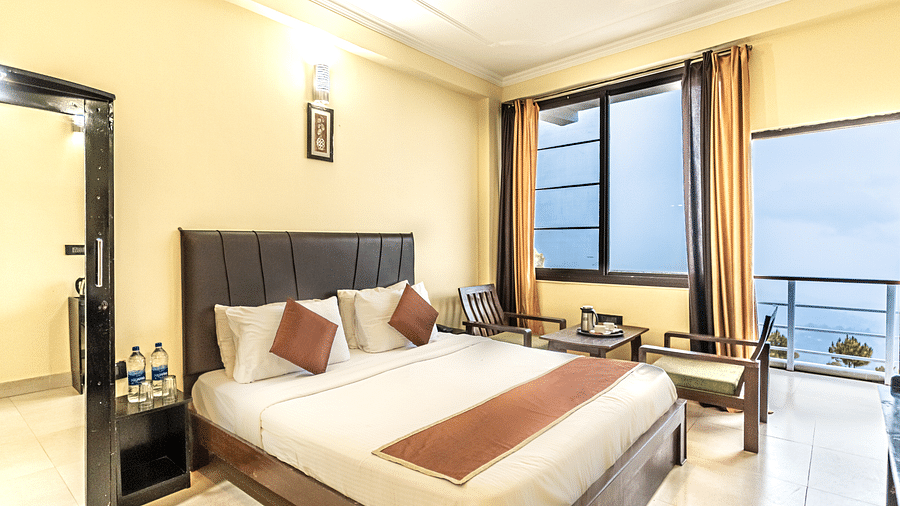 a view of a bedroom at Flutter Hotels & Resorts decked with a bed and a wardrobe