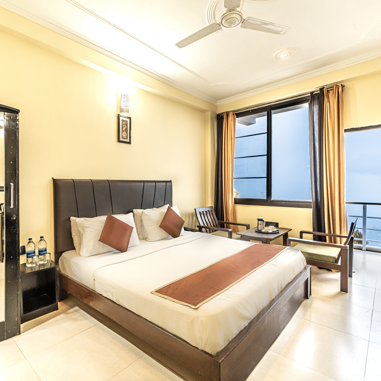 a view of a bedroom at Flutter Hotels & Resorts decked with a bed and a wardrobe