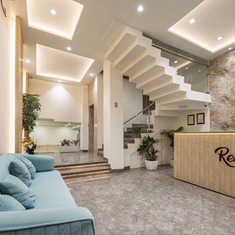 Reception area featuring a sofa and reception desk at Hotel Meghdoot, Bhopal