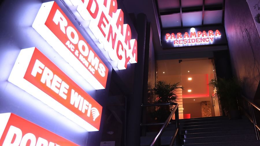 Night view of the entrance of Parampara Residency, Kushalnagar with a signboard on the side.
