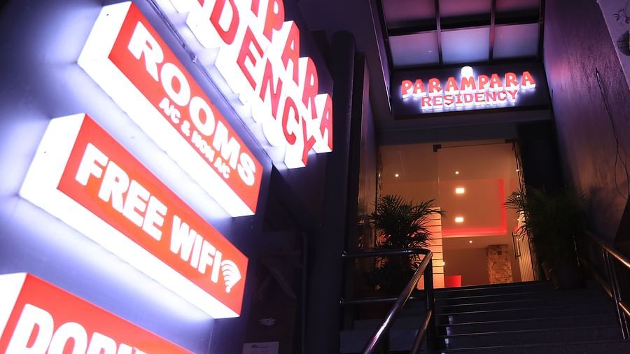 Night view of the entrance of Parampara Residency, Kushalnagar with a signboard on the side .