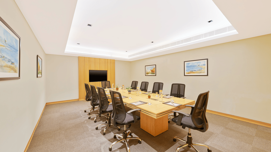 An overview of Waves Meeting Room with a table and many chairs in view | The Resort, Mumbai.