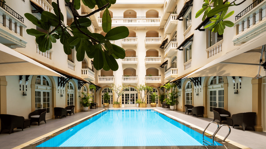 Outdoor swimming pool surrounded by the hotel buildings at Central Mansions, Phnom Penh.