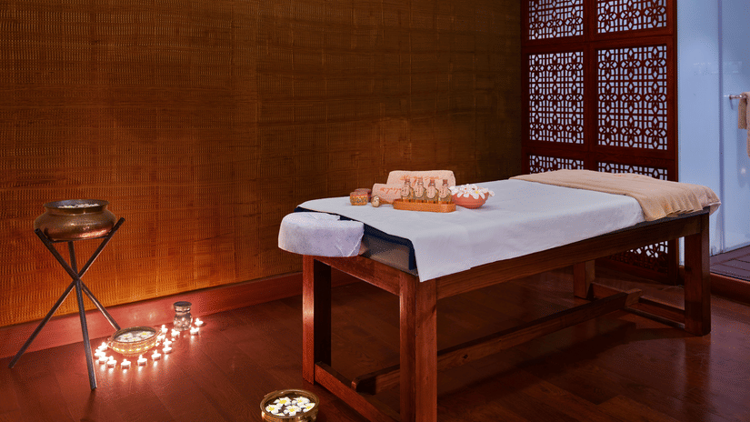 A massage table in our spa room with various treatment products - The Resort, Mumbai.