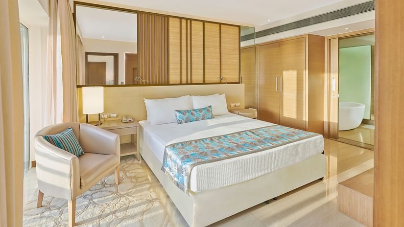 A bed and  a chair in a bedroom | The Resort