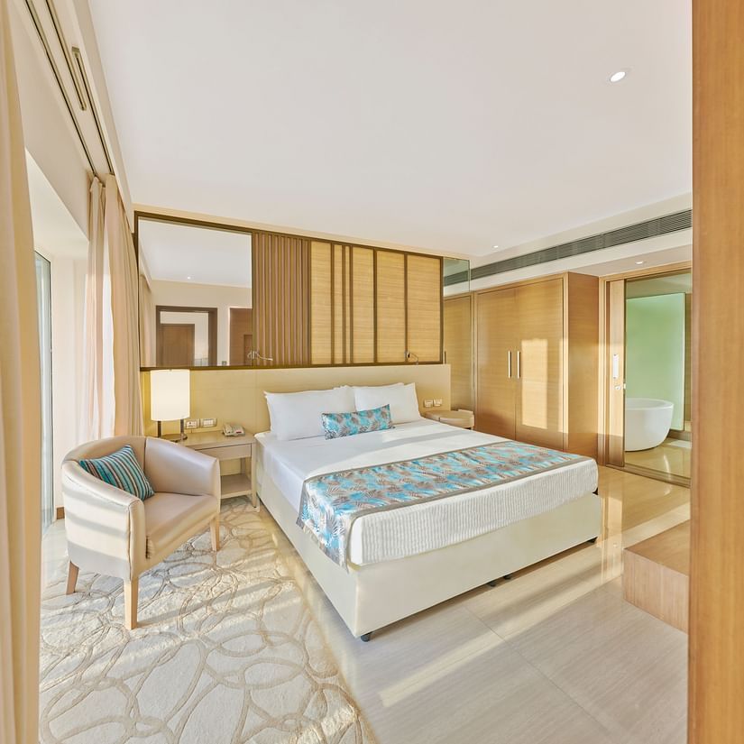 A bed and  a chair in a bedroom | The Resort