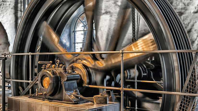 A machine at halt featuring a wheel-like structure under warm lighting
