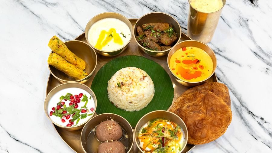 Image of a thali with a variety of food and a drink on the side - The Claridges, New Delhi