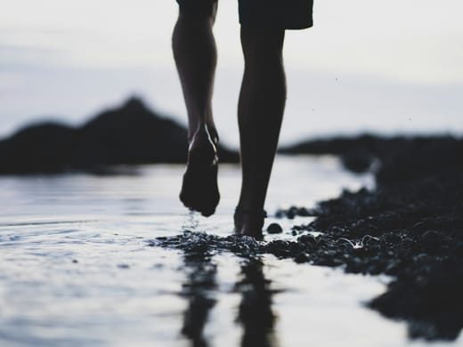 Walking barefoot along the shoreline at dusk near Port Blair