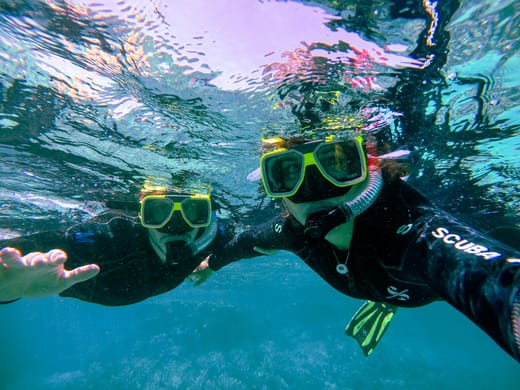 Two snorkellers underwater in the clear Andaman Sea near Port Blair