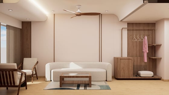 Suite living area with a sofa, a low table, and a wide window | Shirgaonkar Beach Resort