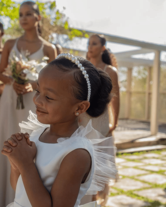 A flower girl smiling ahead of the ceremony at A Stone's Throw Away