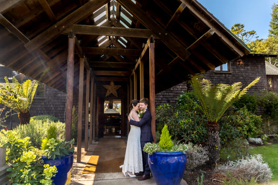 A couple beside the cottage at Brewery Gulch Inn
