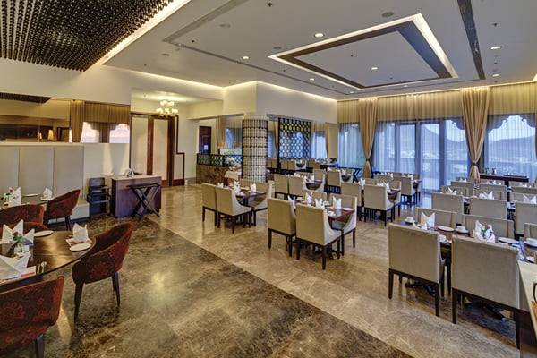 Myra restaurant: restaurant interior with set tables, chairs, glass windows and ceiling light recess