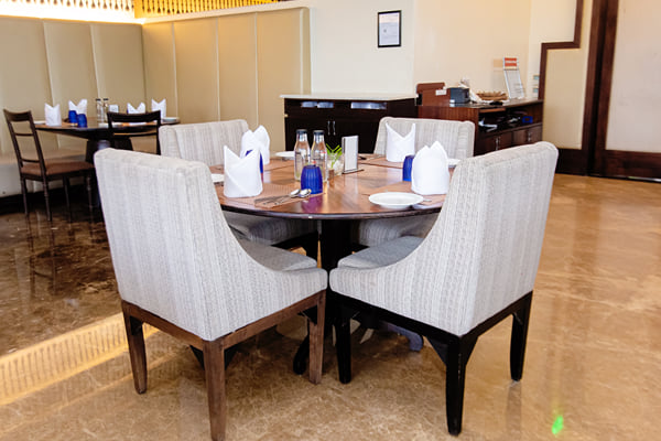 Myra restaurant: round table with two chairs, folded napkins and glasses in a restaurant