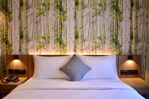 Standard double room with king bed at City Lake Hotel, Bengaluru