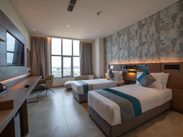 Deluxe Twin room with private balcony at RG Grand Hotel & Convention, Bengaluru