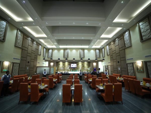 Maxims restaurant dining area at RG Royal Hotel & Convention, Bengaluru