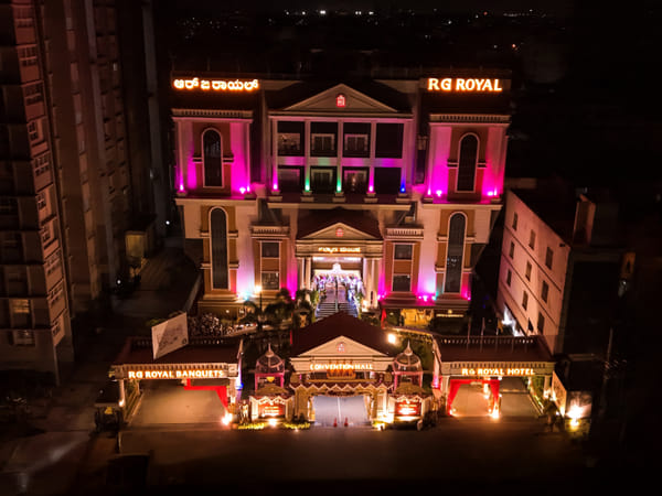 RG Royal Hotel & Convention illuminated at night, Mahalakshmi Layout, Bengaluru