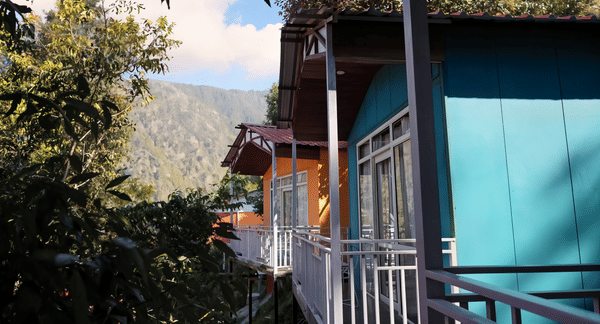Forested mountain valley view from the cottage balconies at Nazaara Nature Retreat, Dalhousie