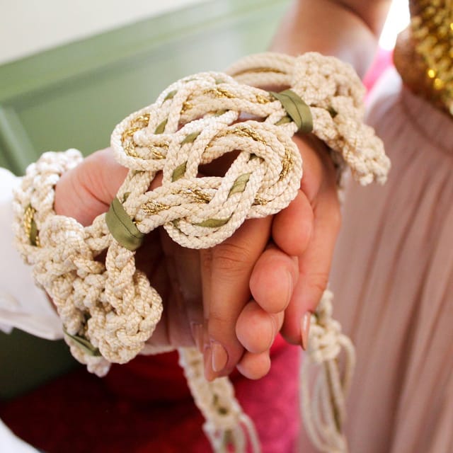 Hands tied together in a Celtic handfasting ceremony