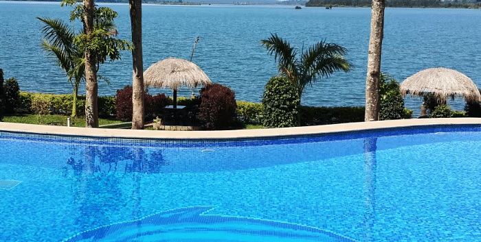 Image of a swimming pool with the view of a waterbody in front at Coorg Jungle Camp Backwater Resort, Kushalnagar.