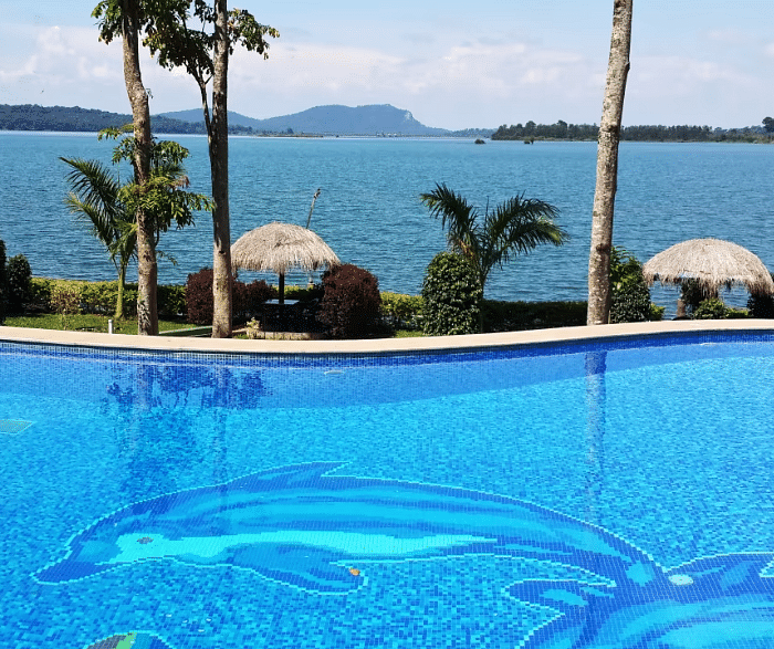 Image of a swimming pool with the view of a waterbody in front at Coorg Jungle Camp Backwater Resort, Kushalnagar.