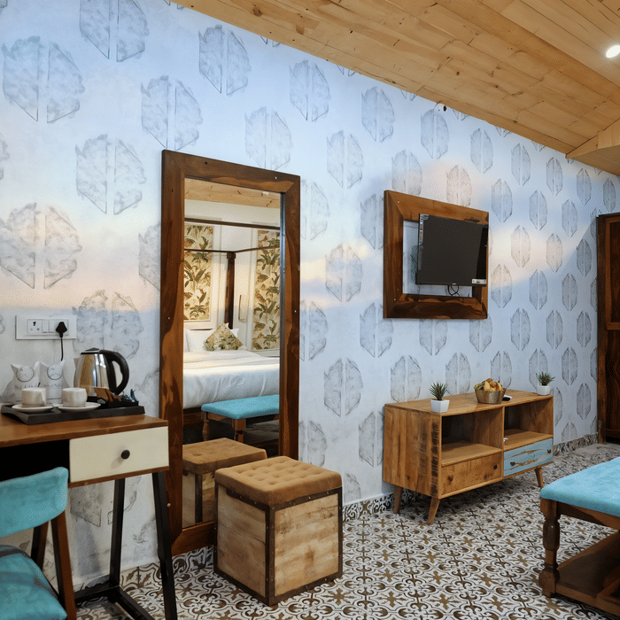 Dressing area with a mirror and wooden vanity beside the wardrobe in a Luxe Cottage room at Nazaara Nature Retreat.