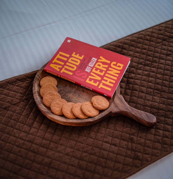 Cookies and a book laid out as a welcome touch in the Nazaara Family Suite at Nazaara Hills Retreat, Udaipur.