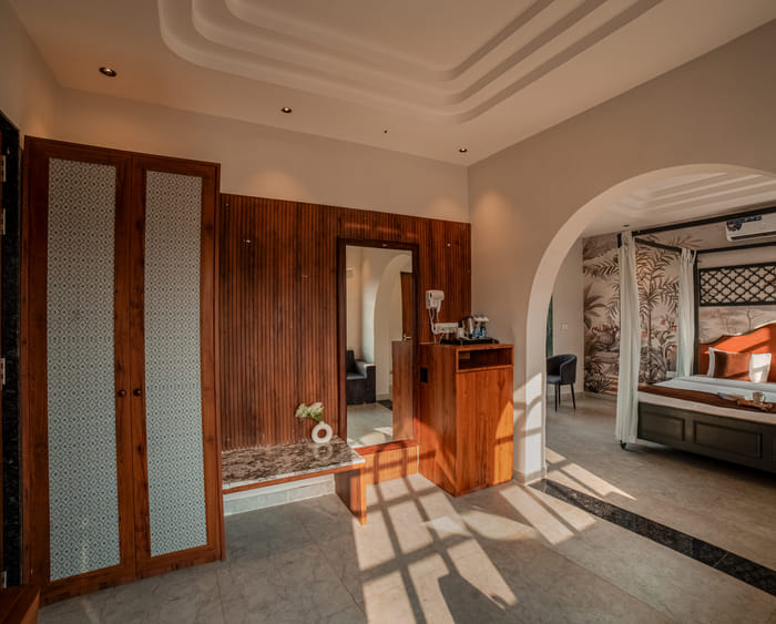 Dressing area with wardrobe and mirror in the Nazaara Royal Suite at Nazaara Hills Retreat, Udaipur.