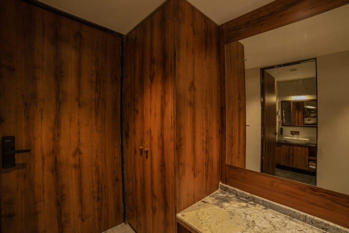 Wardrobe beside the entrance door of the Premium Plunge Pool Room at Nazaara Hills Retreat, Udaipur.