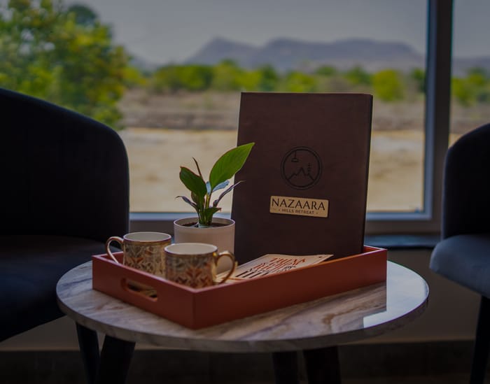 Tea tray with cups and kettle arranged in the Superior Room at Nazaara Hills Retreat, Udaipur.
