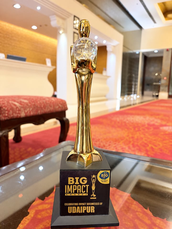 BIG FM BIG Impact Award trophy celebrating impact businesses of Udaipur, displayed in the resort lobby