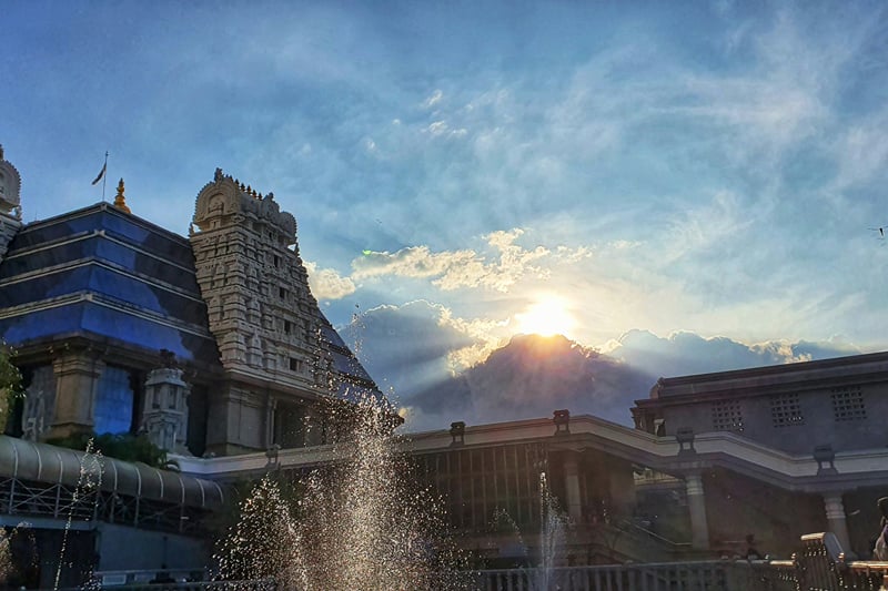 ISKCON Temple gopuram and fountain at sunset